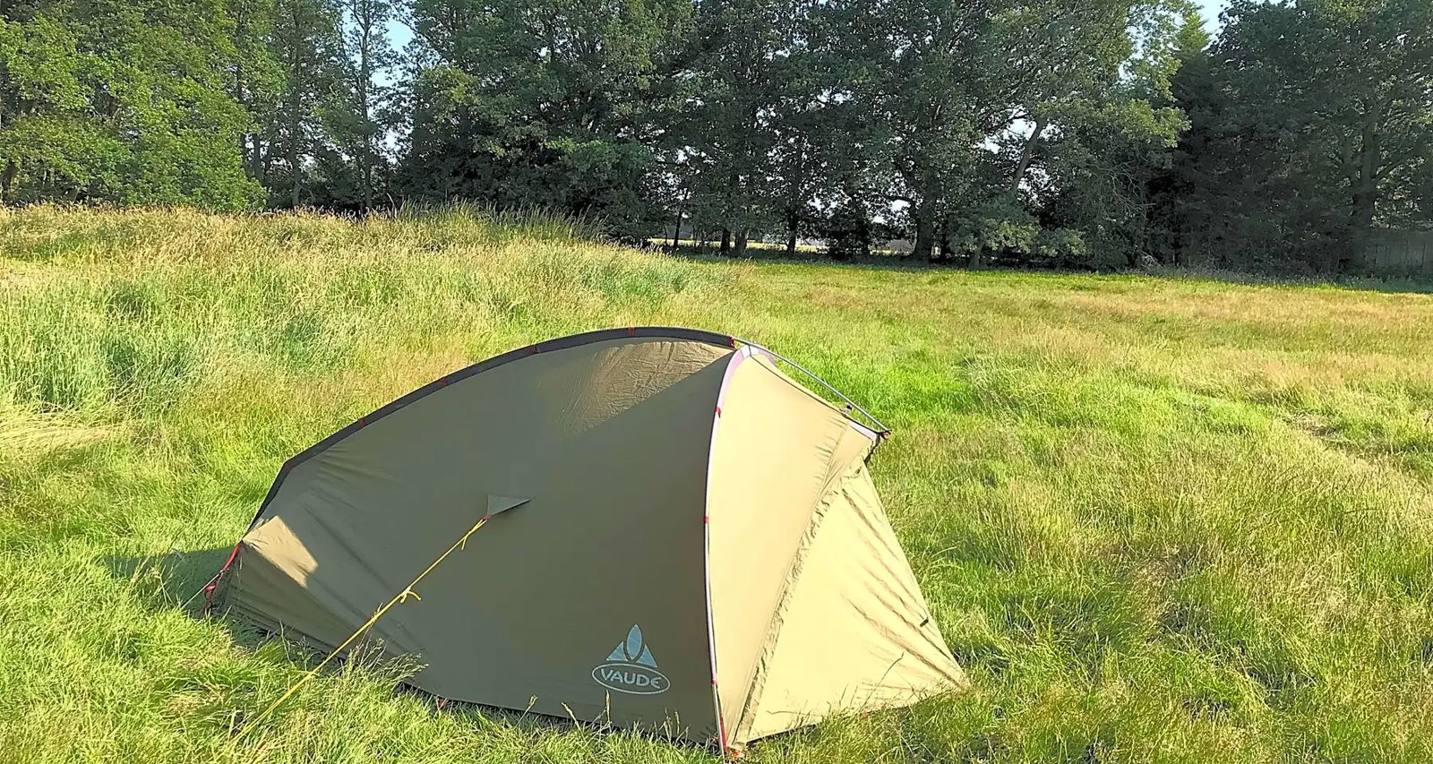 A two-person tent pitched on level grass